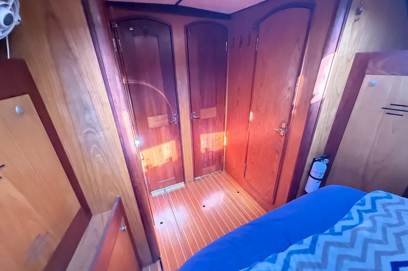 Slide: The Image of Interior of a 2000 Hunter 460 yacht with wooden doors and flooring. - 56
