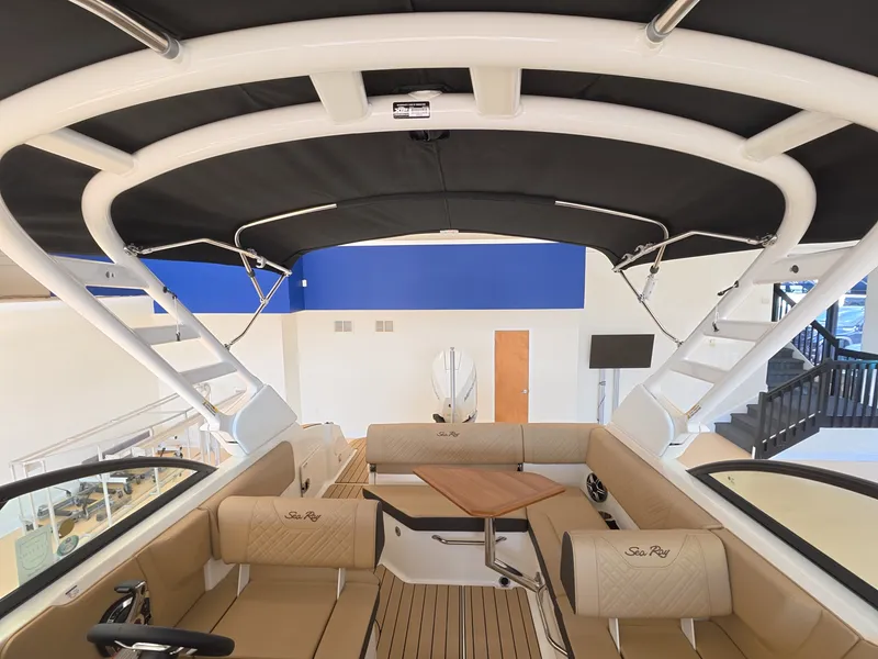 Slide: The Image of Interior view of a Sea Ray SDX 230 Outboard with beige upholstery and a black sunshade. - 7