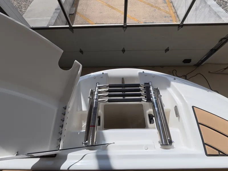 Slide: The Image of The image shows the stern of a Sea Ray SDX 230 Outboard with a retractable swim ladder. - 22