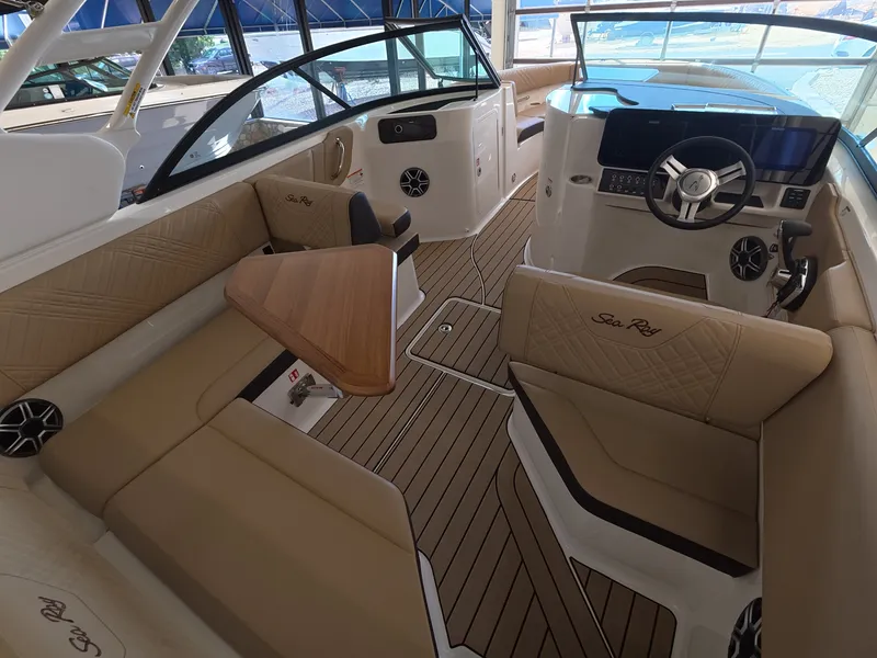 Slide: The Image of Interior of a Sea Ray SDX 230 Outboard with sleek seating and modern helm. - 9