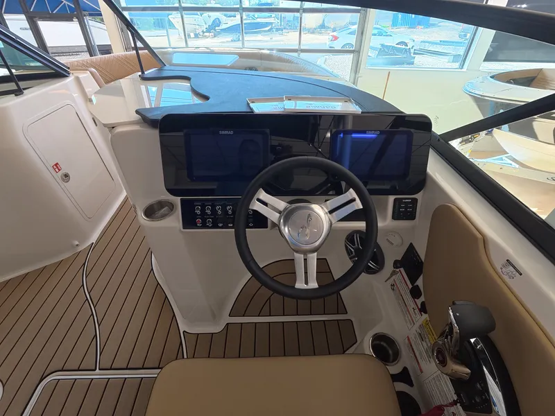 Slide: The Image of The image shows the cockpit of a 2026 Sea Ray SDX 230 Outboard with a modern helm. - 13