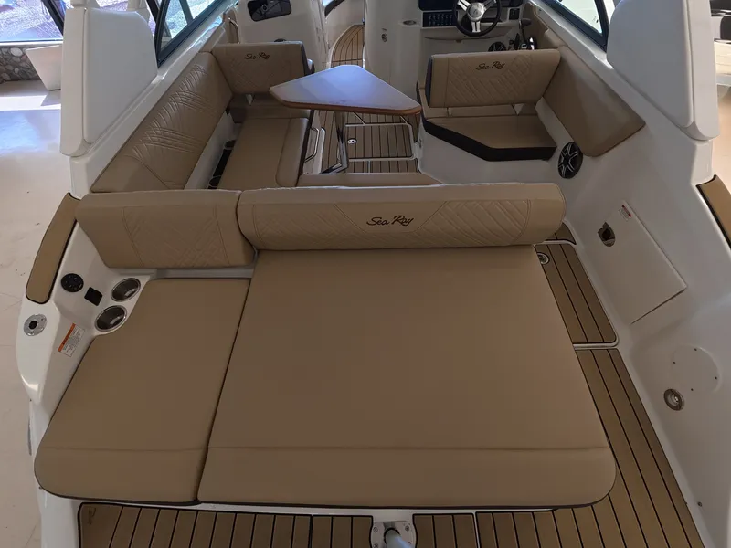 Slide: The Image of The image shows the interior of a Sea Ray SDX 230 Outboard with beige upholstery and wood flooring. - 8