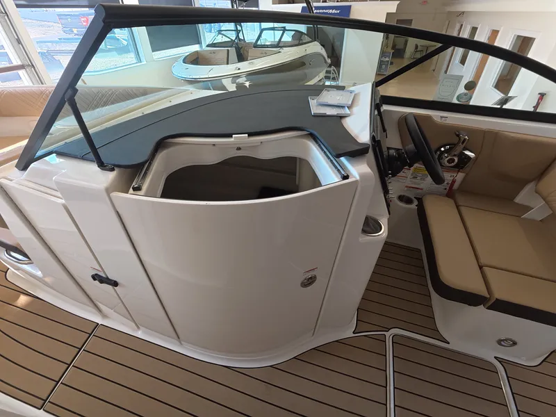 Slide: The Image of The image shows the cockpit of a 2026 Sea Ray SDX 230 Outboard with a beige seating area. - 16