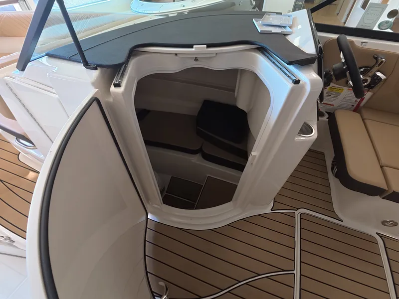 Slide: The Image of The 2026 Sea Ray SDX 230 Outboard cabin features a compact, well-equipped interior. - 17