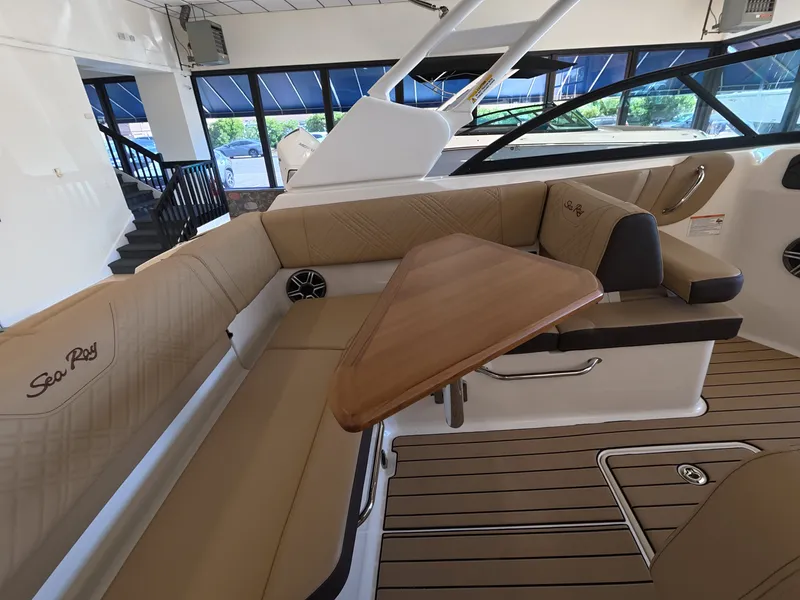 Slide: The Image of Interior of a Sea Ray SDX 230 Outboard with elegant seating and a wooden table. - 10