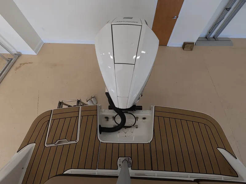 Slide: The Image of The image shows the stern of a 2026 Sea Ray SDX 230 Outboard with an outboard motor. - 3