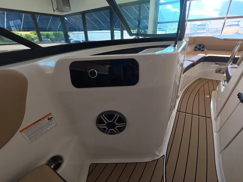 Slide: The Image of Interior of a 2026 Sea Ray SDX 230 Outboard with sleek seating and wood flooring. - 14