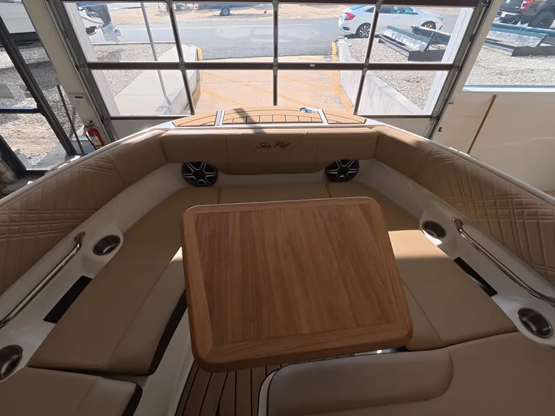 Slide: The Image of The image shows the interior of a 2026 Sea Ray SDX 230 Outboard with elegant seating and a wooden table. - 20