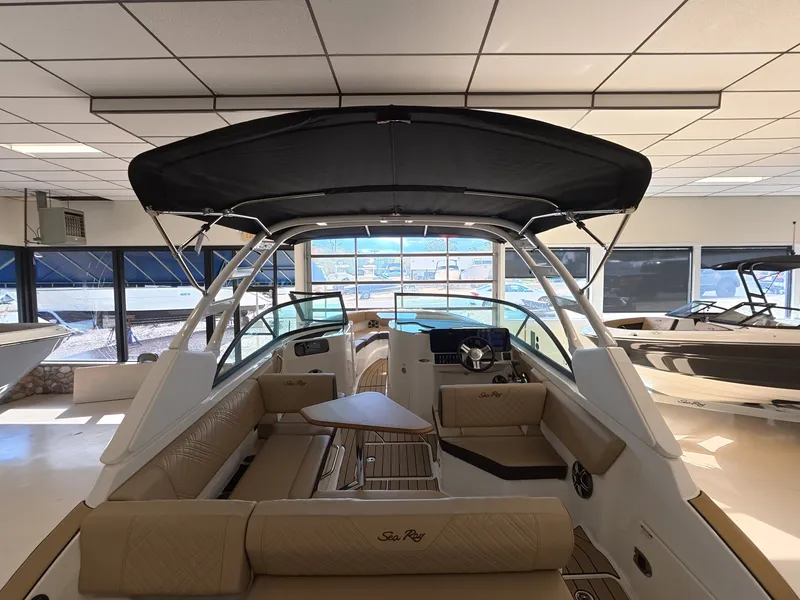 Slide: The Image of Interior view of a Sea Ray SDX 230 Outboard with beige upholstery and a black canopy. - 6