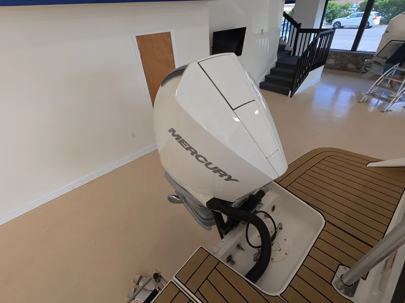 Slide: The Image of A Mercury outboard motor is mounted on a boat with a wooden deck in a showroom. - 4