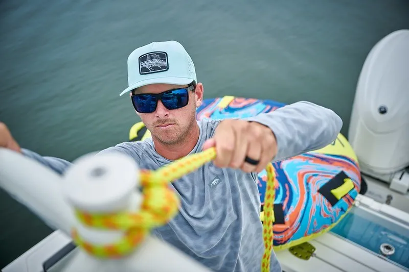 Slide: The Image of Man securing rope on 2027 Cobia 250 Dual Console boat. - 15