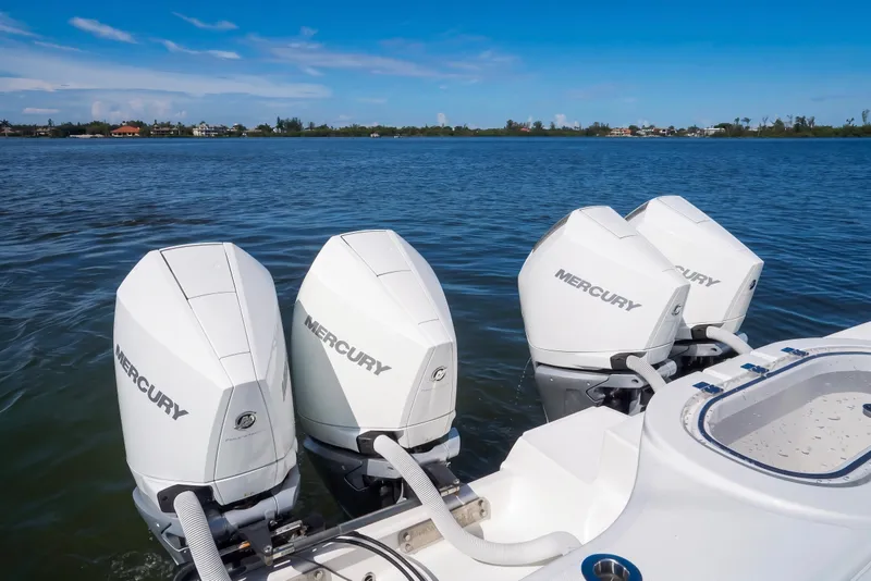 Slide: The Image of Four Mercury outboard engines on a 2019 Invincible 37 Catamaran, cruising on a sunny day. - 30