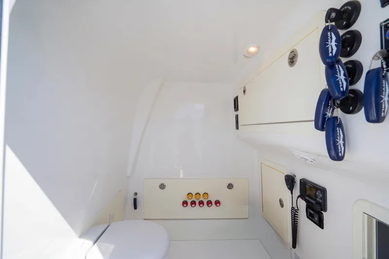Slide: The Image of Interior of 2019 Invincible 37 Catamaran, featuring control panel and storage compartments. - 32