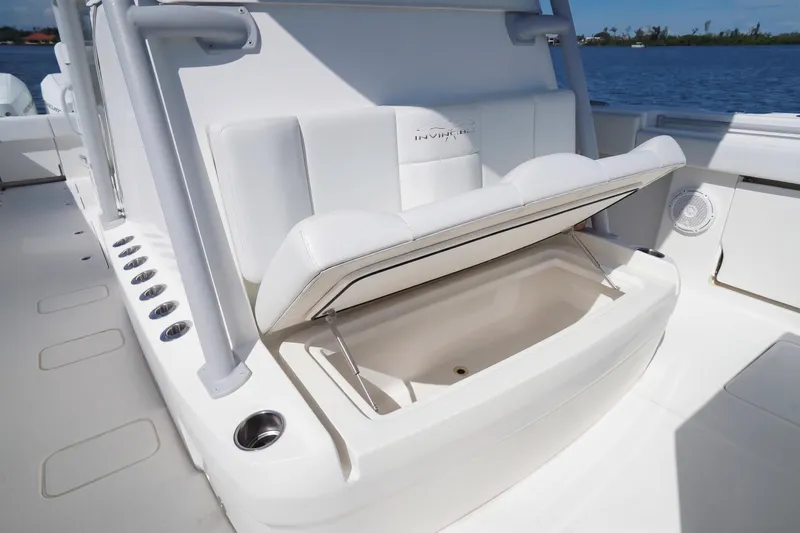 Slide: The Image of 2019 Invincible 37 Catamaran with open storage compartment on deck, near water. - 24