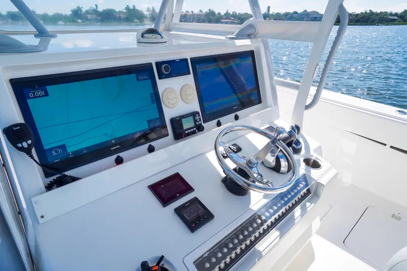 Slide: The Image of Helm of 2019 Invincible 37 Catamaran with advanced navigation displays and controls. - 16
