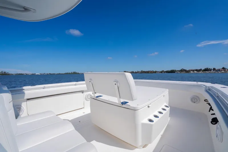Slide: The Image of Invincible 37 Catamaran 2019, spacious deck view, clear blue sky, calm waters. - 21