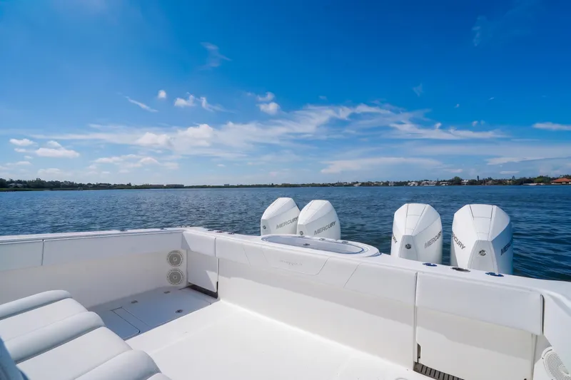 Slide: The Image of 2019 Invincible 37 Catamaran with four Mercury engines on a calm lake under blue skies. - 28