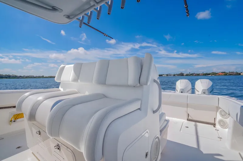 Slide: The Image of Invincible 37 Catamaran 2019 interior with white seating, ocean view, and dual engines. - 25