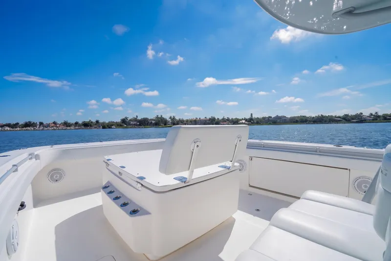 Slide: The Image of Invincible 37 Catamaran 2019 on serene water, clear sky, luxurious seating. - 23