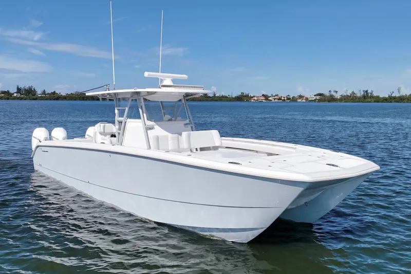 The Image of 2019 Invincible 37 Catamaran on calm water, showcasing sleek design and powerful engines. - 1