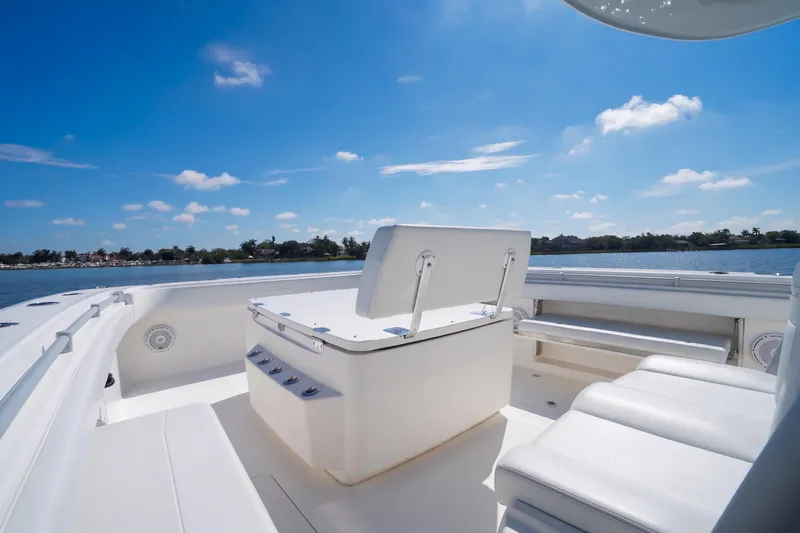 Slide: The Image of 2019 Invincible 37 Catamaran interior with seating, under a clear blue sky. - 18