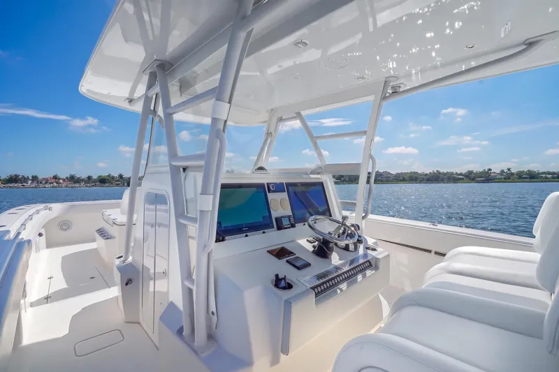 Slide: The Image of 2019 Invincible 37 Catamaran helm with modern controls, overlooking serene waters. - 27