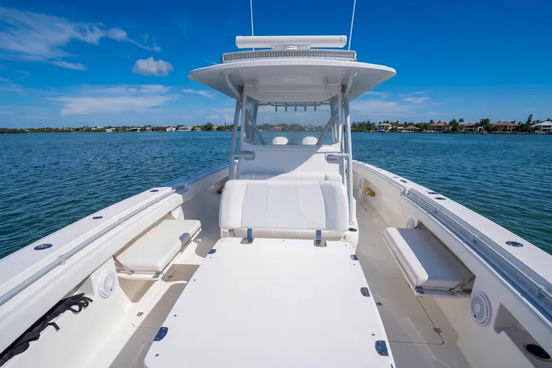 Slide: The Image of 2019 Invincible 37 Catamaran on calm water, showcasing spacious deck and seating. - 22
