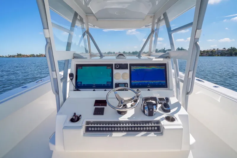Slide: The Image of Cockpit view of 2019 Invincible 37 Catamaran with dual navigation screens and steering wheel. - 14