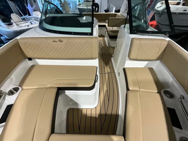 Slide: The Image of Interior view of a Sea Ray SDX 230 Outboard with beige upholstery and wood flooring. - 19