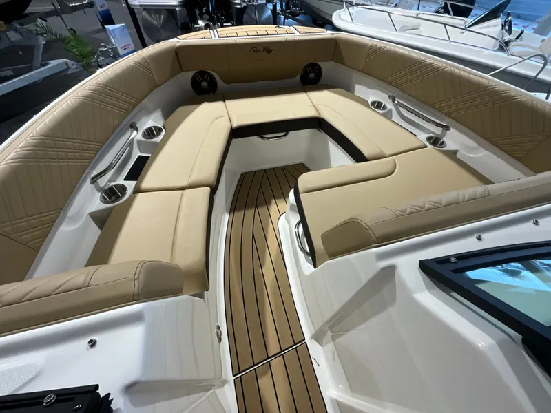 Slide: The Image of The image shows the interior of a Sea Ray SDX 230 Outboard with beige upholstery and wood flooring. - 22