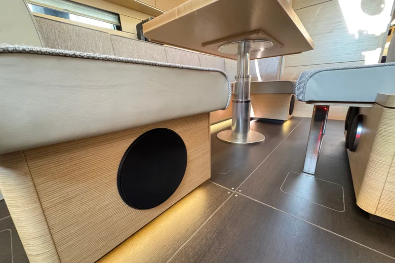 Slide: The Image of Interior of 2025 Hanse 460 yacht, featuring modern seating and sleek wooden finishes. - 14