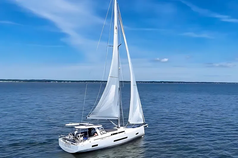 Slide: The Image of Sailing yacht Hanse 460, 2025 model, cruising on calm blue waters under clear skies. - 1