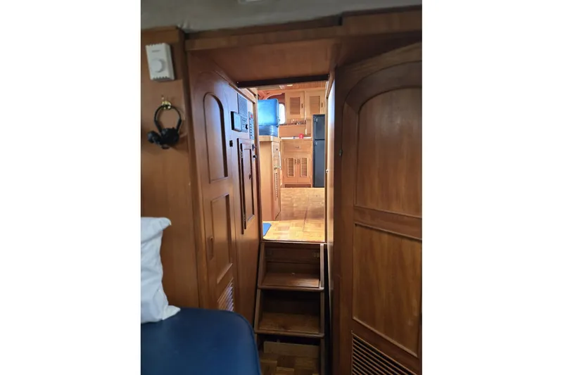 Slide: The Image of Interior view of 1979 Ocean Alexander 40 Double Cabin with wooden finishes and stairs. - 43