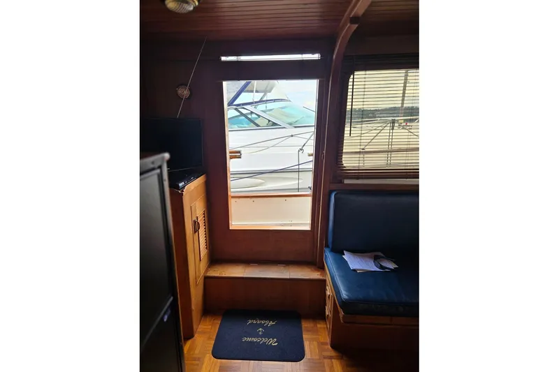 Slide: The Image of Interior view of 1979 Ocean Alexander 40 Double Cabin with wooden finish and seating area. - 52