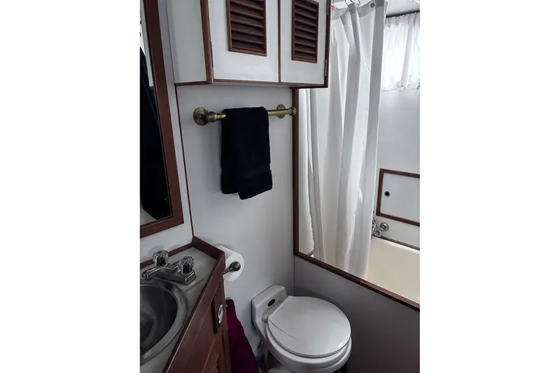 Slide: The Image of Bathroom interior of 1979 Ocean Alexander 40 Double Cabin yacht, featuring sink, toilet, and shower. - 37