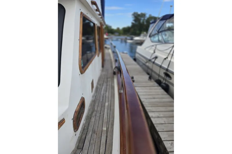 Slide: The Image of Side view of a 1979 Ocean Alexander 40 Double Cabin docked at a marina. - 9