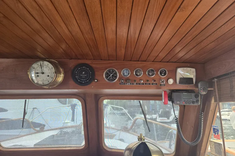 Slide: The Image of 1979 Ocean Alexander 40 Double Cabin helm with vintage gauges and wooden paneling. - 21