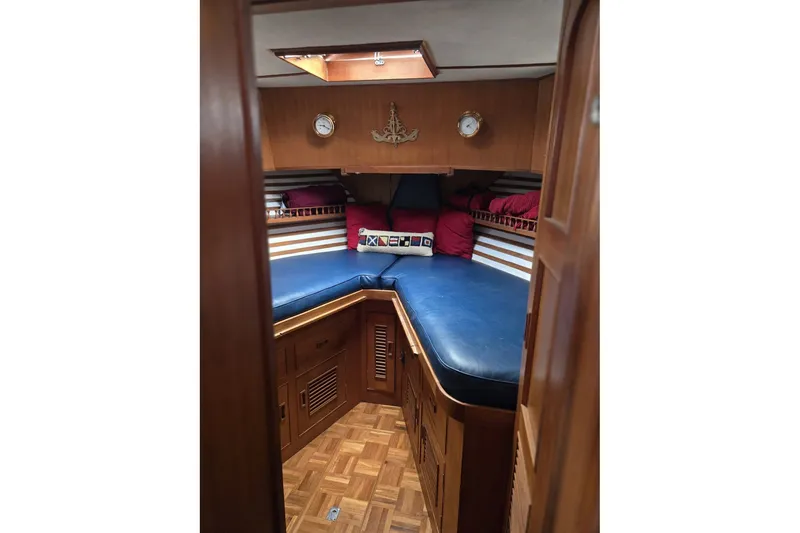 Slide: The Image of 1979 Ocean Alexander 40 Double Cabin interior with blue cushions and wooden cabinetry. - 41