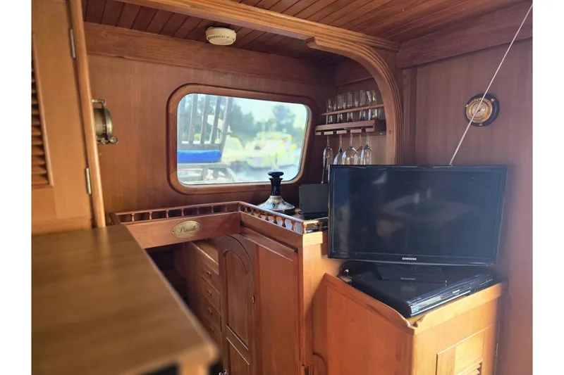 Slide: The Image of Interior of 1979 Ocean Alexander 40 Double Cabin with wood finish and TV setup. - 32