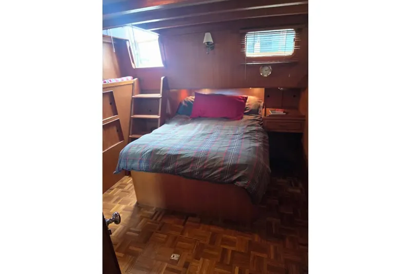 Slide: The Image of Cozy cabin bedroom in 1979 Ocean Alexander 40 Double Cabin yacht with wood paneling. - 33
