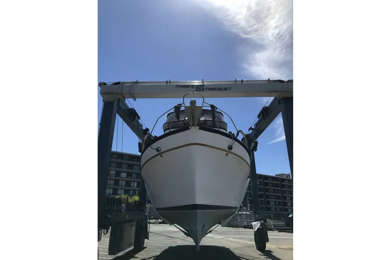 Slide: The Image of 1979 Ocean Alexander 40 Double Cabin yacht on a travel lift under clear sky. - 67
