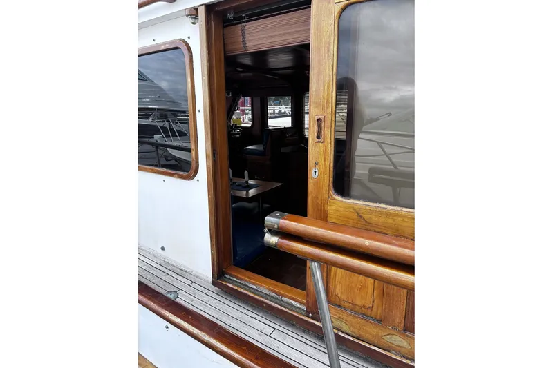 Slide: The Image of 1979 Ocean Alexander 40 Double Cabin yacht with wooden door and interior view. - 10