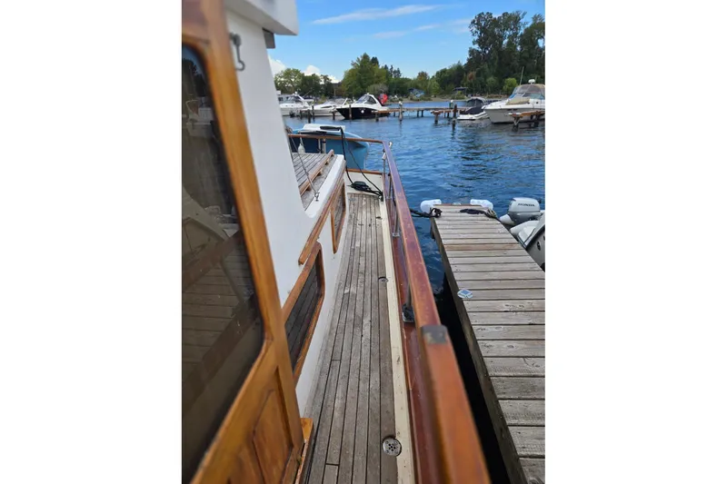 Slide: The Image of 1979 Ocean Alexander 40 Double Cabin yacht docked at marina, wooden deck view. - 53