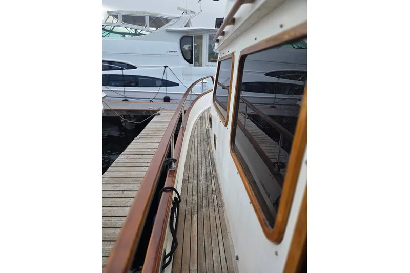 Slide: The Image of 1979 Ocean Alexander 40 Double Cabin yacht docked beside a wooden pier. - 5