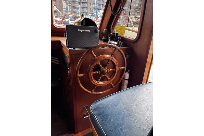 Slide: The Image of Wooden helm of 1979 Ocean Alexander 40 Double Cabin with Raymarine equipment. - 17