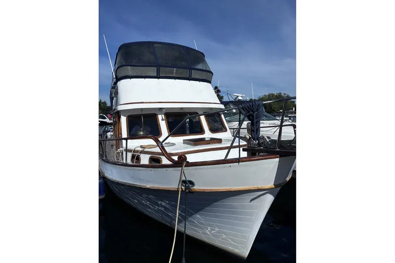 Slide: The Image of 1979 Ocean Alexander 40 Double Cabin yacht docked under clear blue sky. - 3