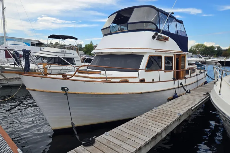 Slide: The Image of 1979 Ocean Alexander 40 Double Cabin yacht docked at marina. - 1
