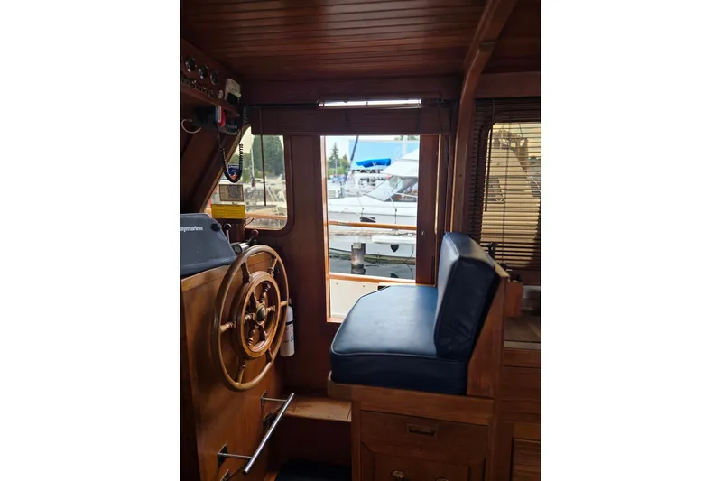 Slide: The Image of Interior of 1979 Ocean Alexander 40 Double Cabin with wooden helm and blue seat. - 18