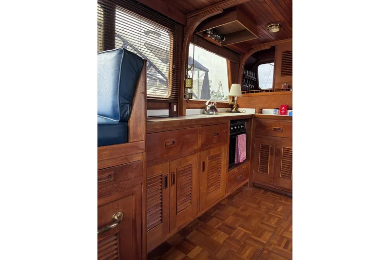 Slide: The Image of 1979 Ocean Alexander 40 Double Cabin interior with wooden cabinetry and nautical decor. - 25