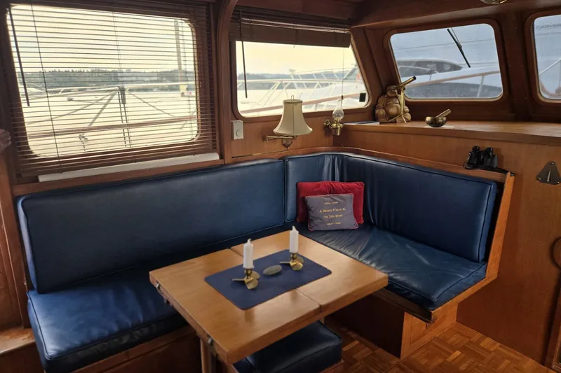 Slide: The Image of Interior of 1979 Ocean Alexander 40 Double Cabin with blue seating and wooden table. - 13